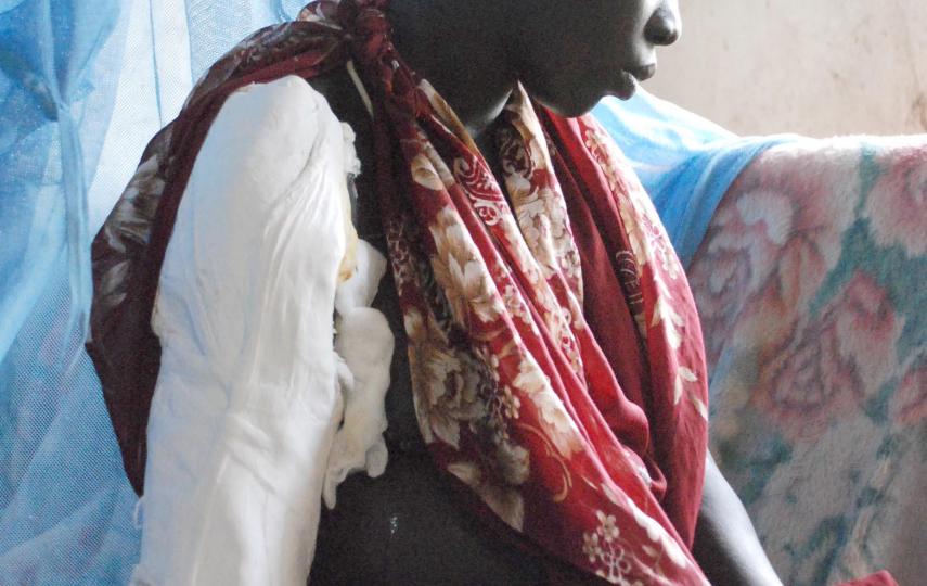 A southern Sudanese woman recovers in Akobo hospital from gunshot wound to her arm and a spear thrust in her back in this 7th August photograph. The woman, who is pregnant, survived a massacre at her fishing village in which 185 people were killed