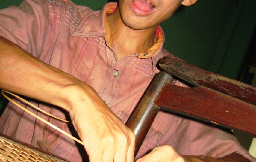Myo Myint Oo making a chair with cane strips. There are few job opportunities for the blind in Myanmar