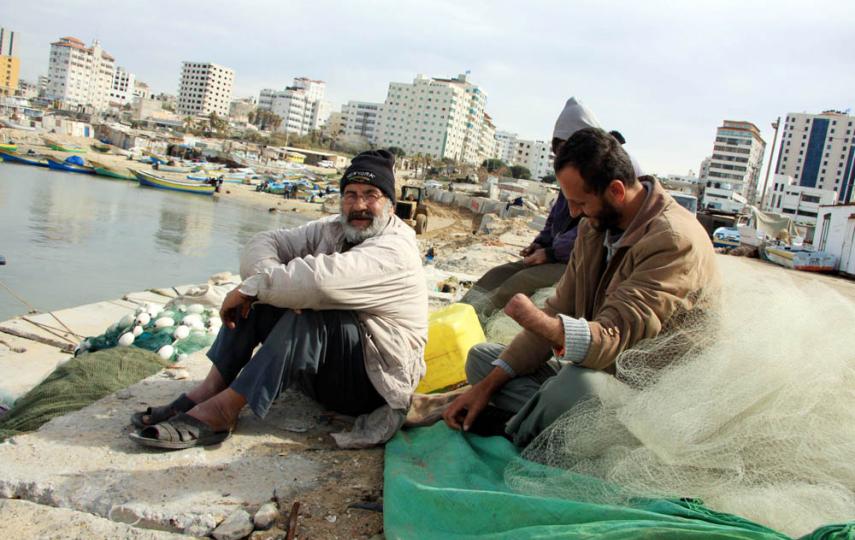 Sami al-Qouqa, a 30-year-old former fisherman from al-Shati refugee camp in northern Gaza, lost his left hand when his fishing boat came under fire from an Israeli gunboat on 12 March 2007. He sits with his fishermen friends in Gaza port