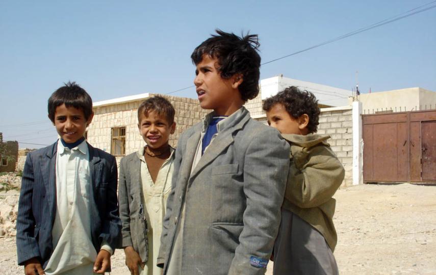 Children in front of their school in southern Saada are happy to see it reopening