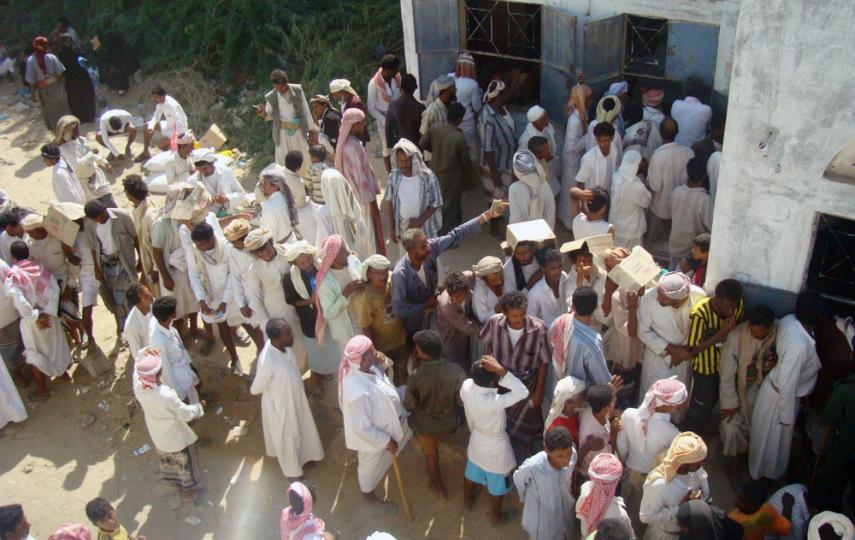 IDPs gather to receive food from a WFP distrubution centre in Haradh city, 40km from Mazraq camp in Hajjah Governorate