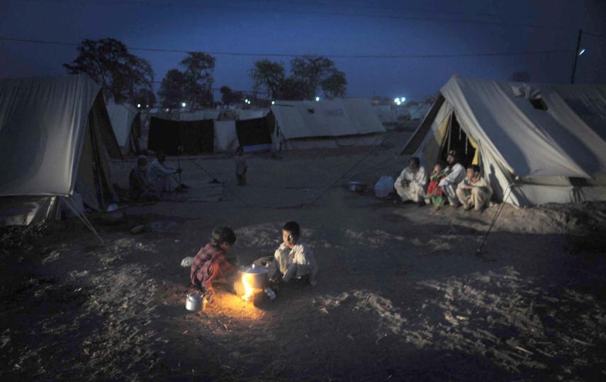 As winter sets in, IDPs huddle around a small fire at a camp in the Dera Ismail Khan district. Winterization of tents is going on and warm bedding is being distributed, but despite such efforts life is tough as temperatures fall steadily