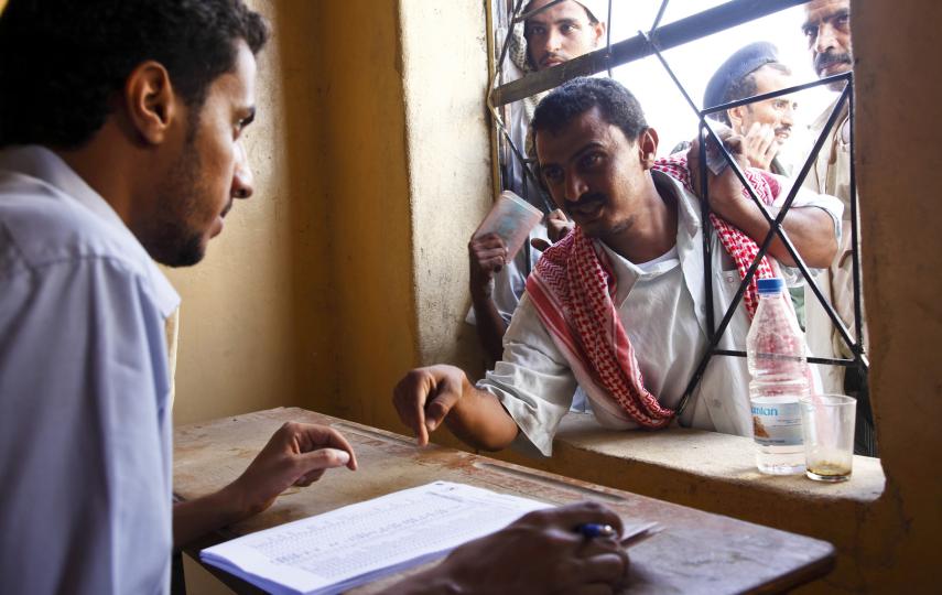 A man living outside Mazrak camp registers to receive his allowance of grain, beans and cooking oil from a World Food Programme distribution centre in the local capital, Harad. August 2009