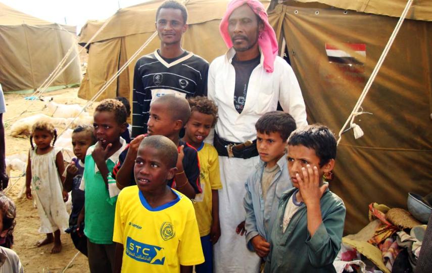 IDPs next to their tents in Mazraq Camp. Up to 270,000 people had been displaced by the latest flare-up