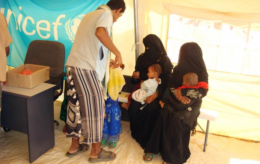 Mothers bring their children to a vaccination centre run by UNICEF in al-Mazraq Camp One in Haradh District, Hajjah Governorate, northern Yemen