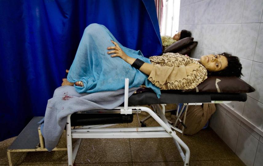A woman in labour lies in pain in the obstetrics ward at Mirwais Hospital in Kandahar, Afghanistan