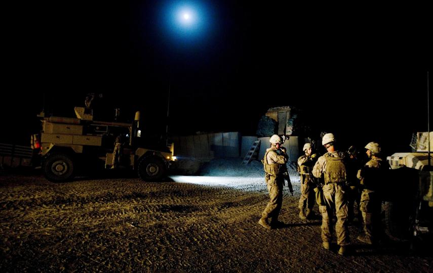 Marines gather for a briefing before going out on night patrol in Mian Poshteh
