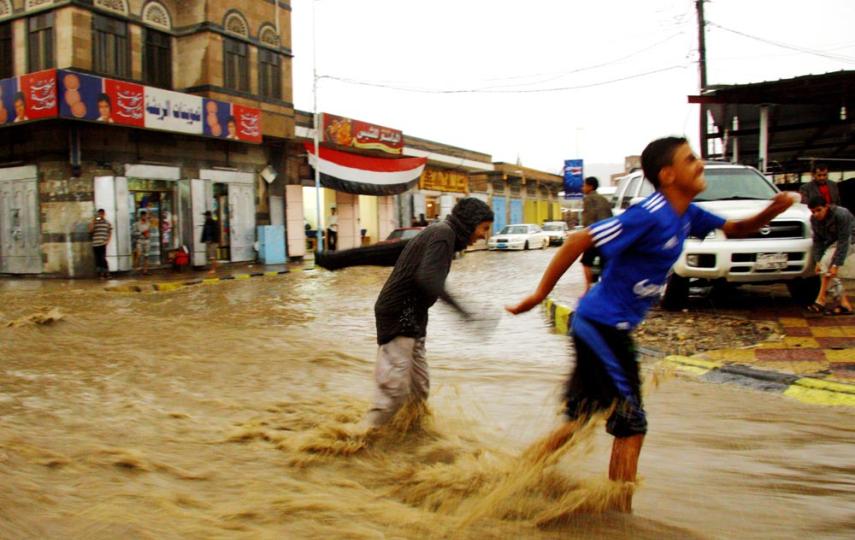 Children play in the flooded streets of Sana'a, the Yemeni capital, while the government fails to harvest the precious rainwater