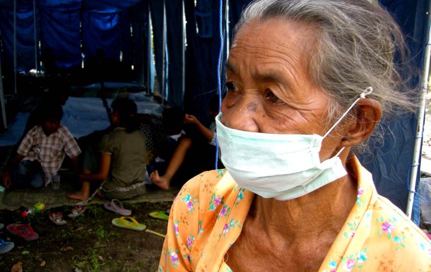 An elderly woman awaits assistance at an evacuation centre for those displaced by the Mount Merapi volcano in central Java. 27 October, 2010