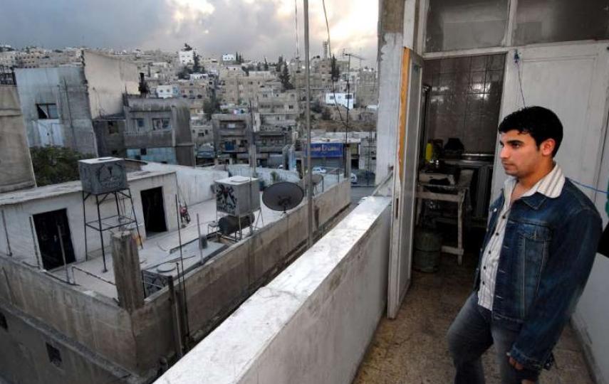 An Iraqi refugee looks out over Amman. Of the estimated two million Iraqis who have fled their homeland, some 700,000 are currently sheltering in Jordan, with the majority living in Amman