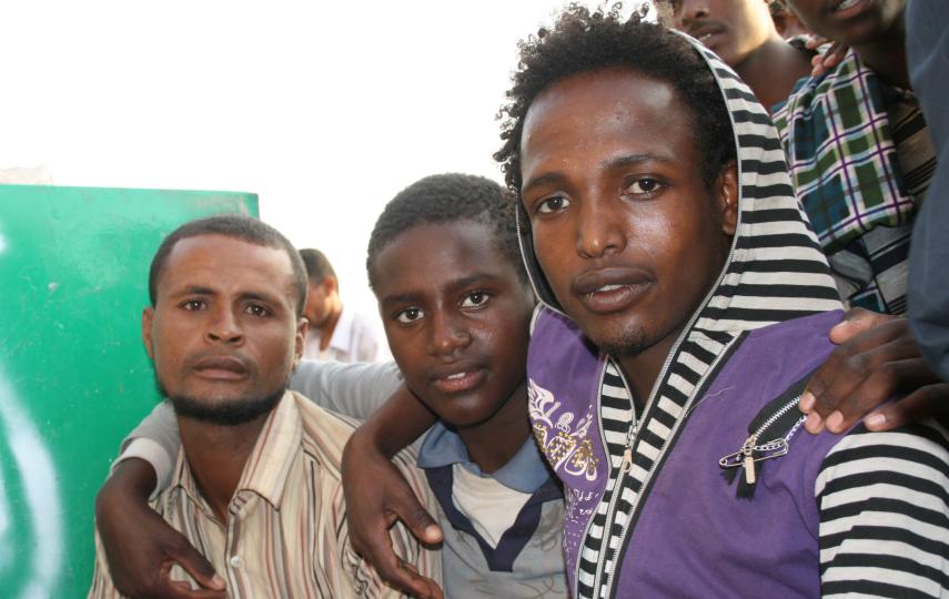 Ethiopians migrants sitting outside the offices of the Charitable Society for Social Welfare in Haradh, Yemen