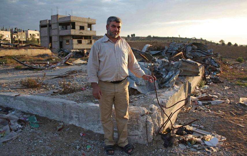 Farid Batch standing next to the remnants of his home in Jabalia, Gaza Strip
