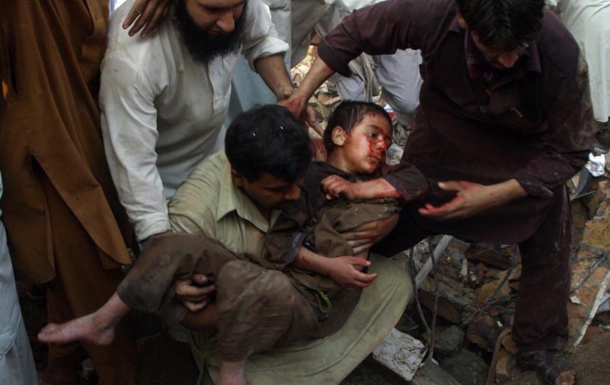An injured boy is carried out of a busy bazaar in the city of Peshawar after a bombing on October 28th, 2009