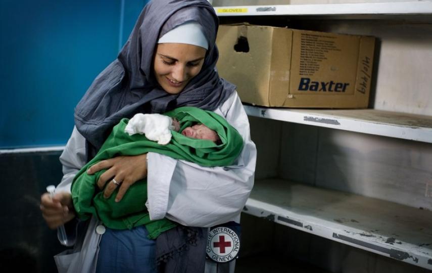 An ICRC nurse holds a newborn baby delivered by caesarean section at Mirwais Hospital in Kandahar, Afghanistan