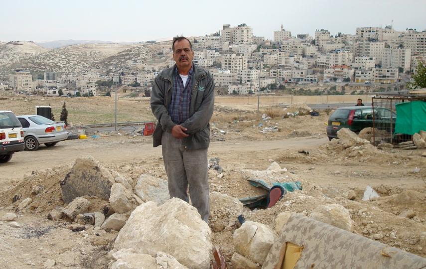 Nayeem Sbatan stands amid the rubble of his commercial garage in At-Tur, East Jerusalem, after it was demolished by Israeli authorities on 29 December 2010