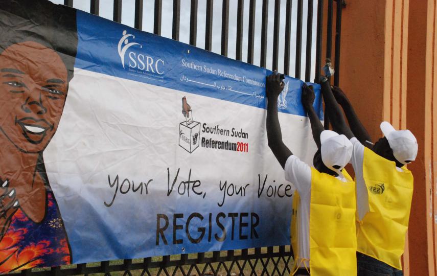 Officials from the South Sudan Referendum Commission hang posters in the southern capital Juba to encourage people to register for a 9 January ballot that is likely to lead to the secession of Southern Sudan