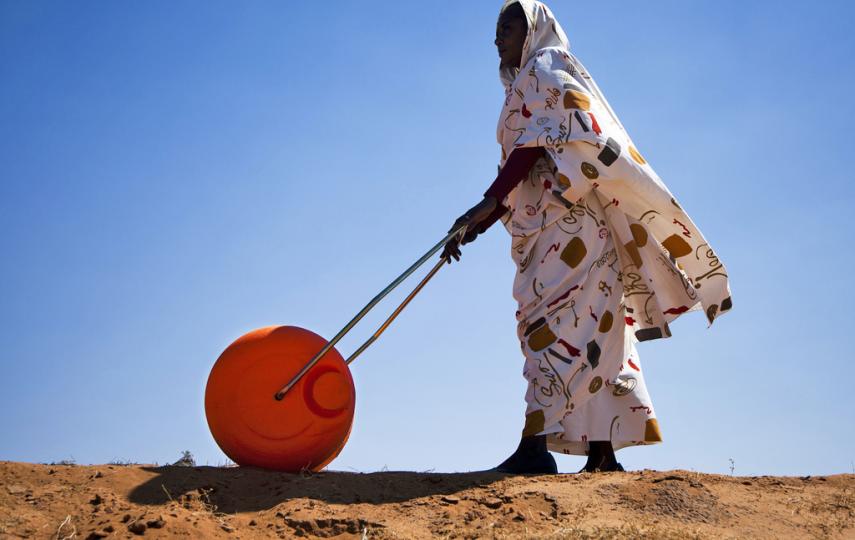 A woman in El Fasher, North Darfur, uses a Hippo Water Roller, a device for easily and efficiently carrying water. The "hippo roller", with its large drum capacity (usually 75 litres), frees women and children from having to spend a large portion of every