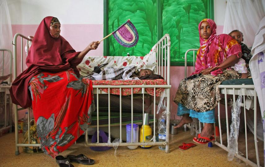 Mothers sit with their malnourished and dehydrated children in a ward at Banadir Hospital in the Somali capital Mogadishu