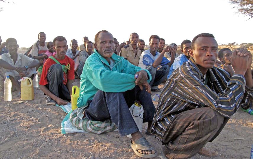 Migrants form queues to be counted by their smuggler prior to being transported by boat from Obock to Yemen