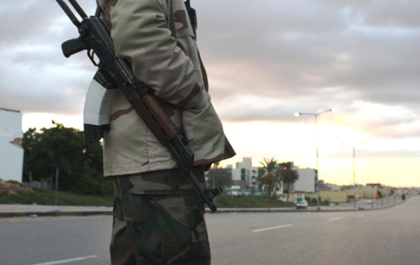 A Libyan revolutionary blocks off a road during a demining operation in Tripoli in November 2011