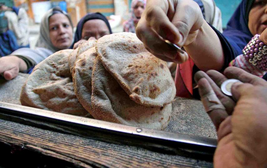 Customers buy bread at a bakery in Cairo