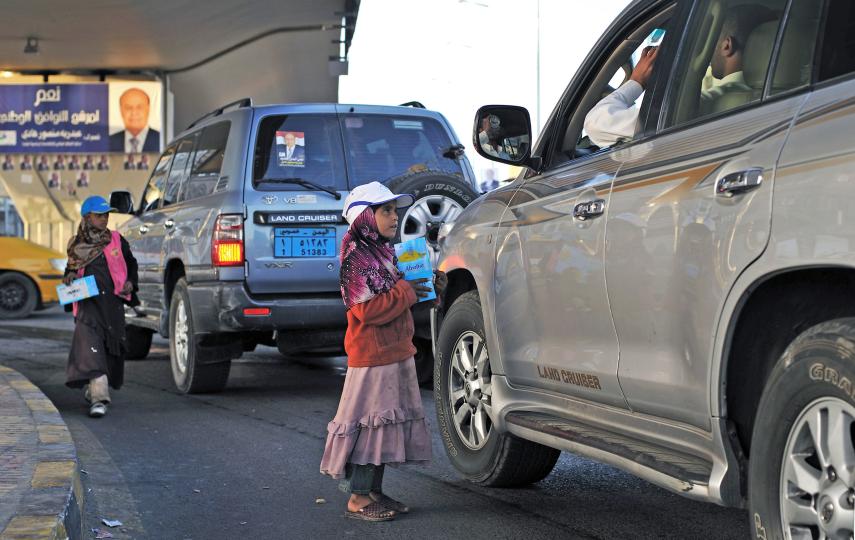 Yasmine Hajiri and her sister sell tissues to passing drivers at an intersection in downtown Sana'a on February 15, 2012. Hajiri's family took her and her sisters out of school so that they could help generate income by selling tissue after the family sto