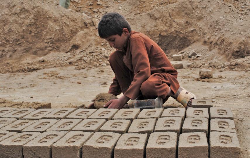 A boy makes bricks at a kiln in Afghanistan