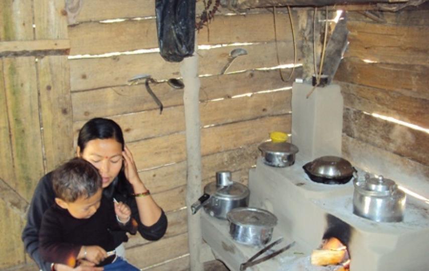 A mother and child inside their home in Pashupatinagar, Ilam District. Indoor air polution is a leading cause of death in Nepal