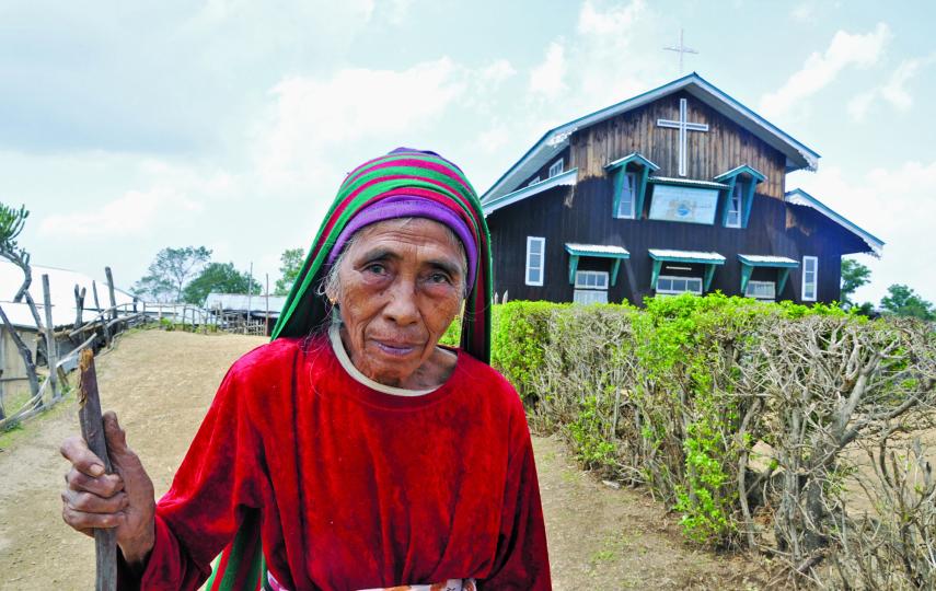 An elderly woman and a church in western Chin State. Approximately 90 percent of all Chin are Christian