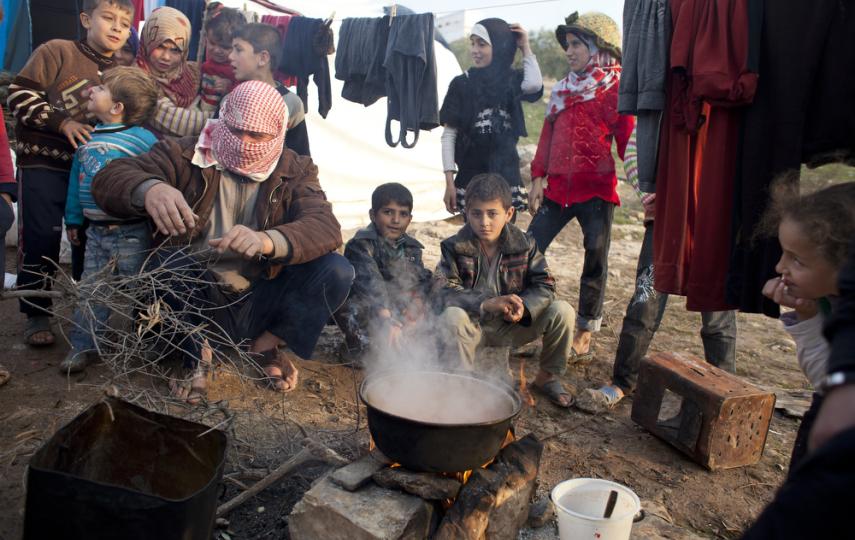 Tomato and potato soup being cooked on an open fire at Qah Camp for displaced Syrians. The nearly 4,000 displaced people living at Qah Camp lack electricity or stoves. With the arrival of winter, the situation has become desperate. Camp officials say they
