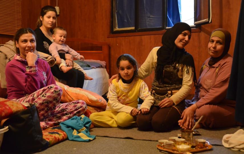 Manal Tayyar and her family sit in a small rented room in Tyre, in South Lebanon, after fleeing their homes in Rural Damascus, Syria