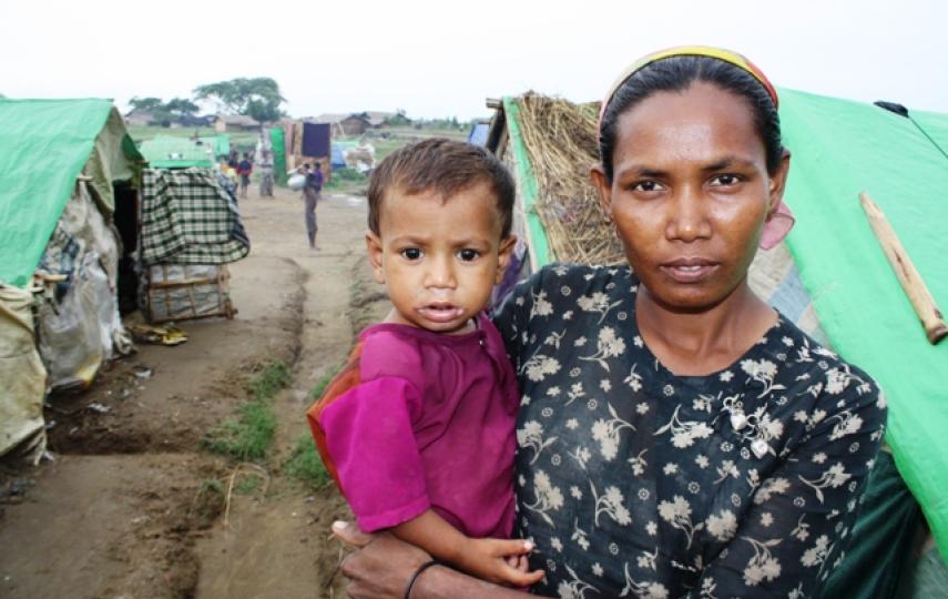 A Rohingya woman and her child look to the camera at a makeshift camp outside Sittwe in Myanmar's western Rakhine State in May 2013. An estimated 140,000 people were displaced following sectarian violence in 2012, the vast majority Rohingya Muslims