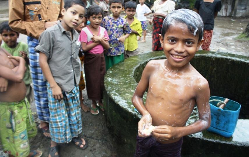 A young Rohingya boy bathes at the Sin Tet Maw IDP camp in Pauktaw Township, western Rakhine State. WASH remains a key challenge more than one year after sectarian violence left more than 140,000 people displaced