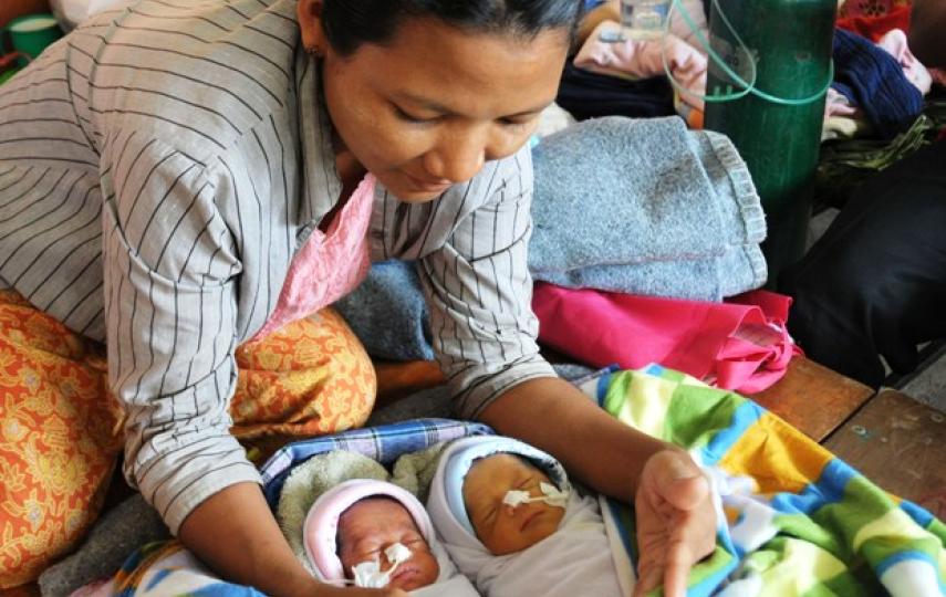 Burmese national Nin Moe Aye sits with her newborn twins who were being treated for low birth weight at a Thai clinic in Mae Sot. The country’s infant mortality rate is 48 per 1,000 live births while the mortality rate for children under five is 62 per 