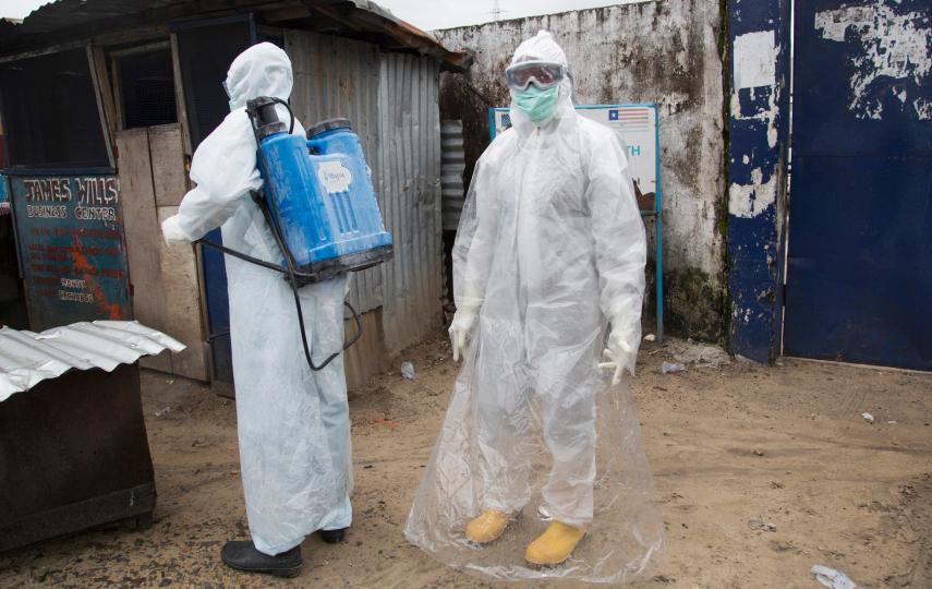 A team cleans an area where a suspected Ebola patient sat outside waiting hours for treatment - potentially infecting others in the process. (Sep 2014)