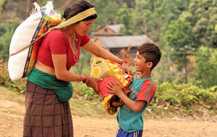 A displaced mother walked for hours with her son to get food relief and a blanket in the village of Kharanitar in Nepal's Nuwakot district. Supplies are often dropped far away from remote villages