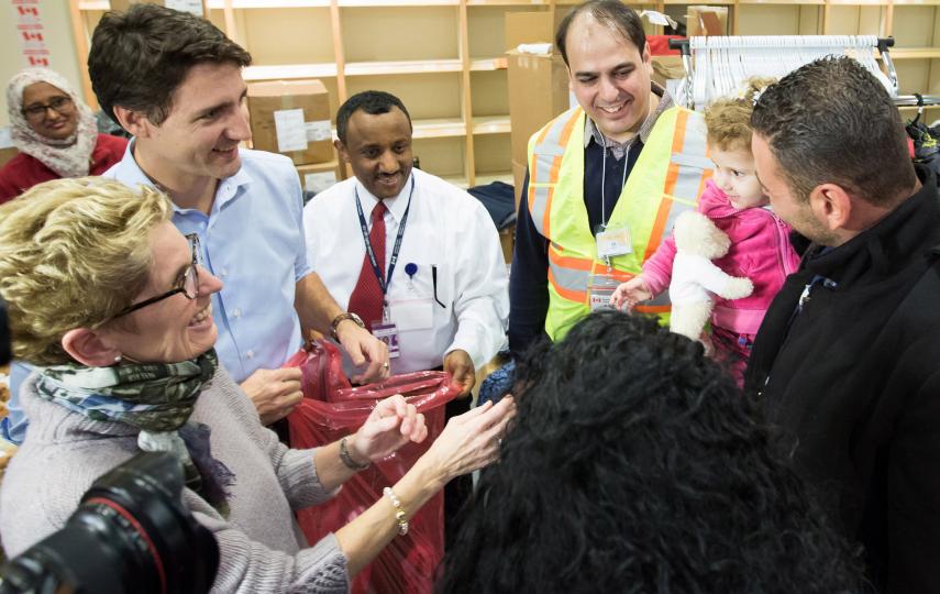 Canadian Prime Minister Justin Trudeau and Ontario Premier Kathleen Wynne welcome Syrian refugees Kevork Jamkossian and his daughter Madeleine who were among 163 Syrians to arrive in Canada on 10 December, the first of 10,000 expected before the end of 20