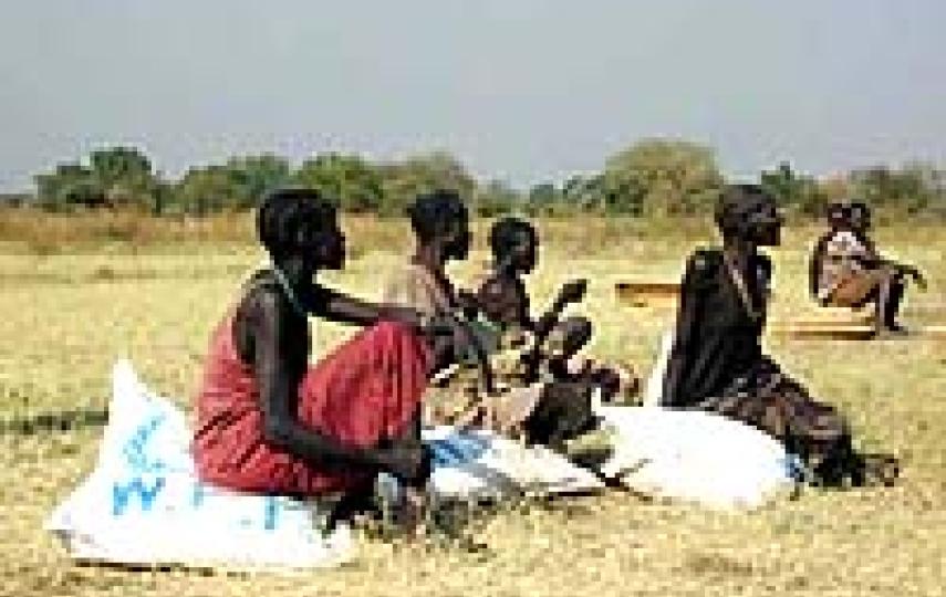 [Sudan] Women rest after receiving their monthly WFP food ration in Maiwut, Southern Sudan.