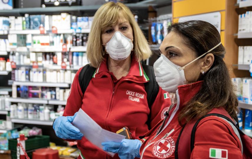 Italian Red Cross volunteers collect medicines at a pharmacy