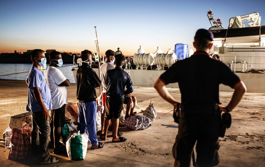 Photo shows migrant waiting to board a quarantine ferry in Italy. 