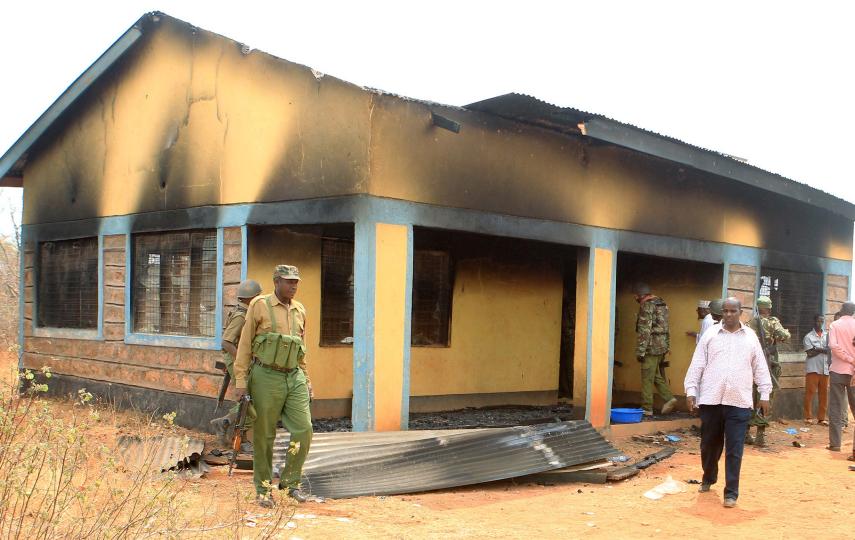 Security officers and residents assess the damage at a teacher's house in Mandera county