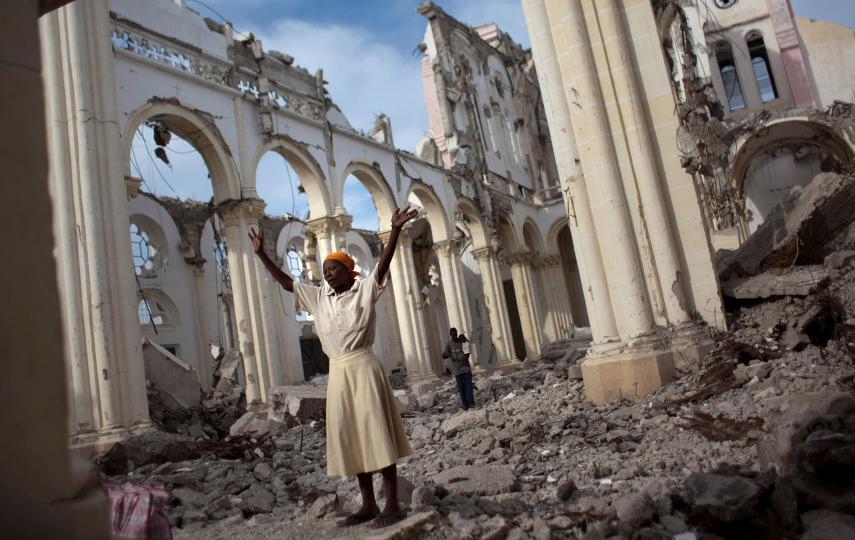 A woman prays among the rubble of the Cathedral of Our Lady of the Assumption that got destroyed in the 12 January 2010 earthquake in Port-au-Prince, Haiti.