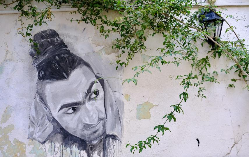 A portrait of Adam Jawad painted on the walls of the cultural centre where he worked in Amman.