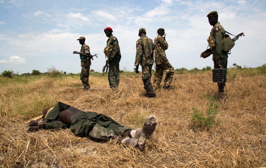 Victorious SPLA soldiers and dead rebel