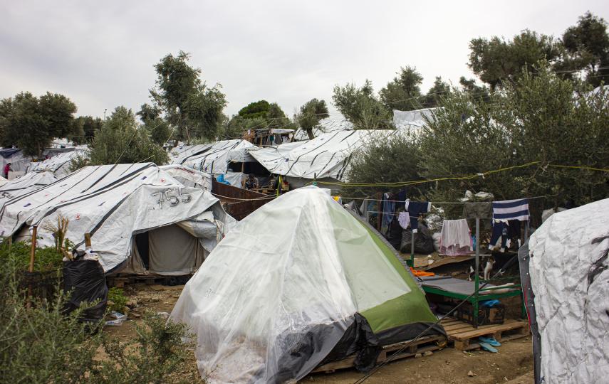 Plastic draped over a tent in an attempt to waterproof it from the rain.