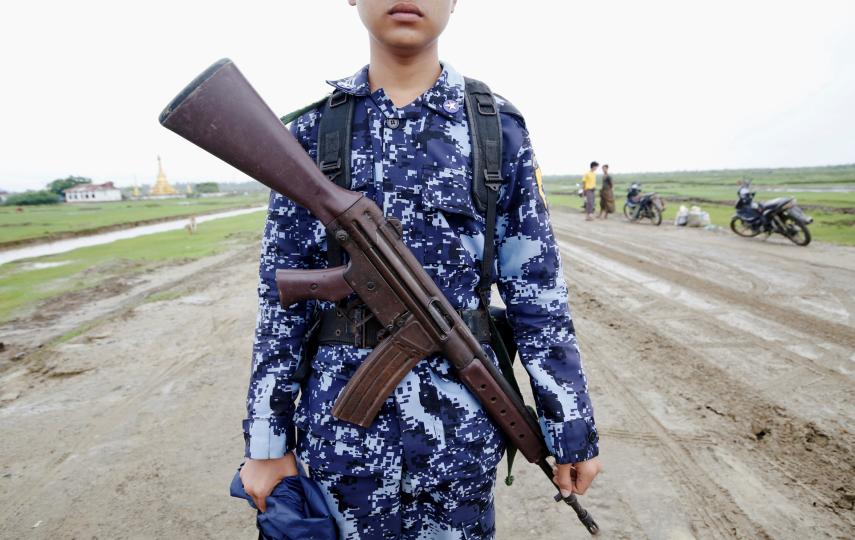 A Myanmar police officer poses for a photo in Rakhine State’s Maungdaw township in July 2019. It’s one of nine townships where the government has blocked mobile internet as of February 2020.