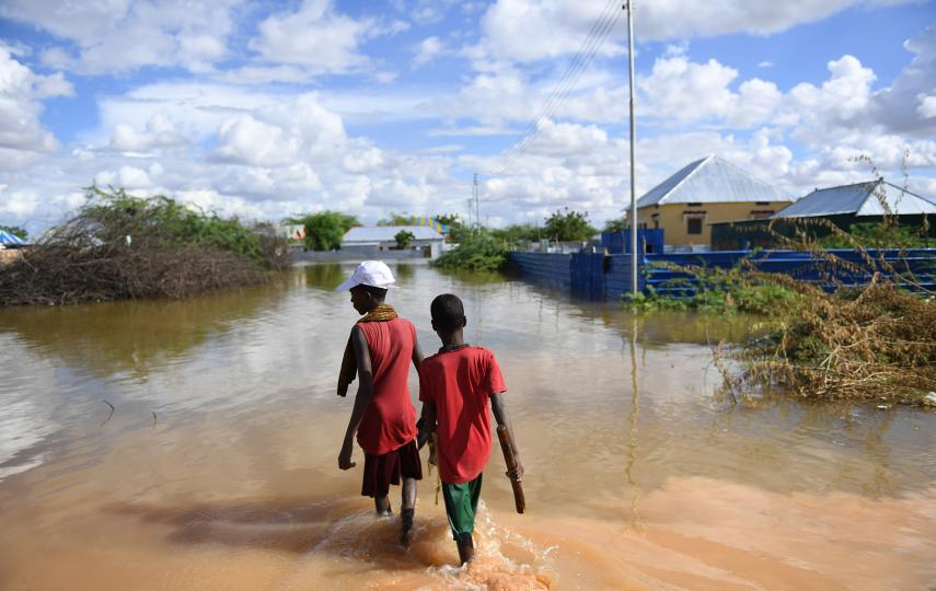 Young boys of Hawa-taako walk through a section of the flooded residential area in Belet Weyne, Somalia in 2018.