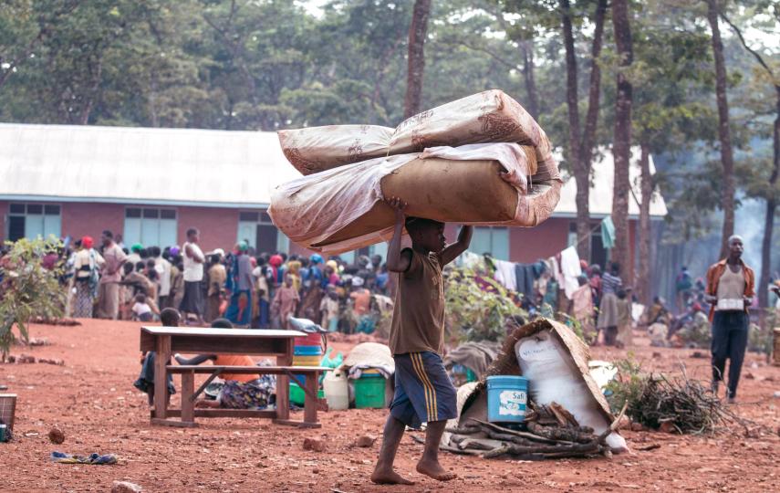 A child carries a mattress in Nyarugusu refugee camp, Tanzania.