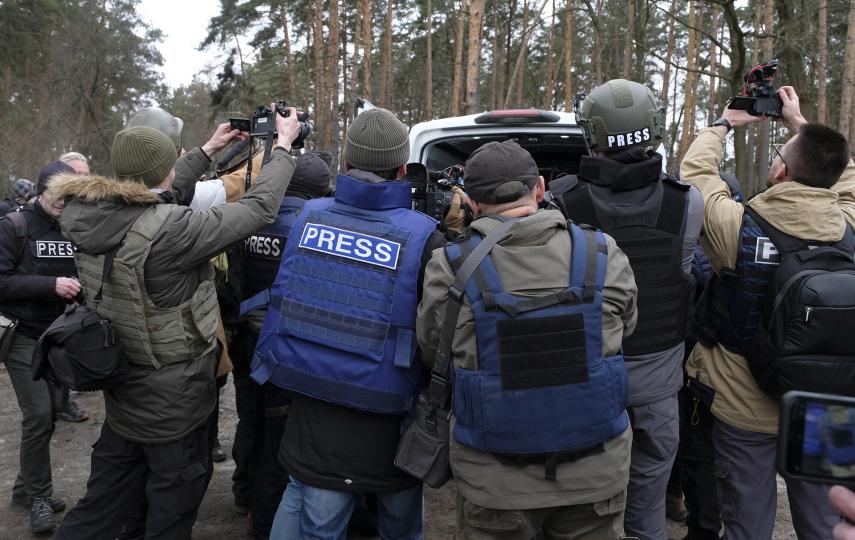 A media scrum surveys destroyed Russian military machinery during a trip to Bucha, near Kyiv, organised by the Ukrainian authorities on 5 April 2022. Coverage of other conflicts and humanitarian crises around the globe is often scant.