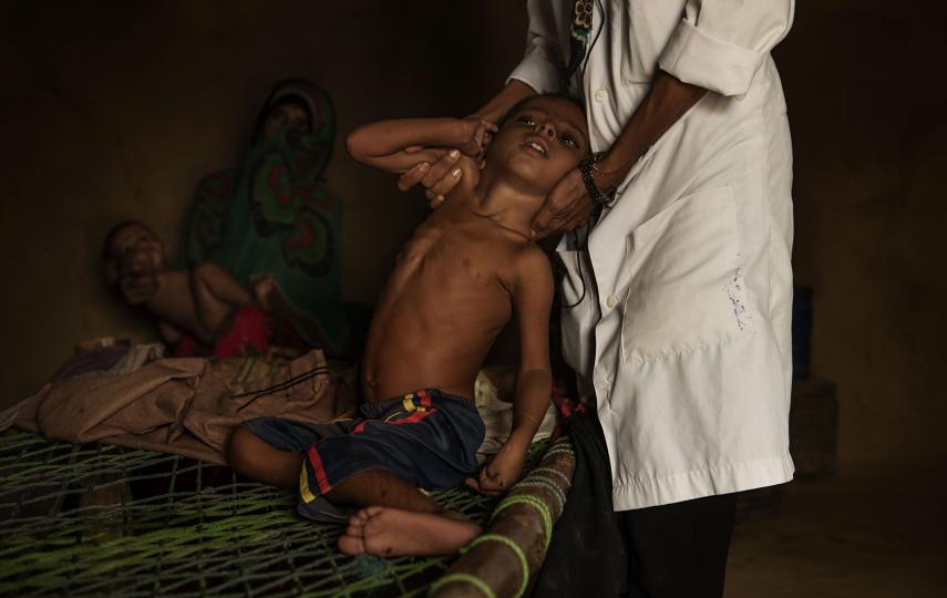 Photo of a nurse and child in rural Yemen